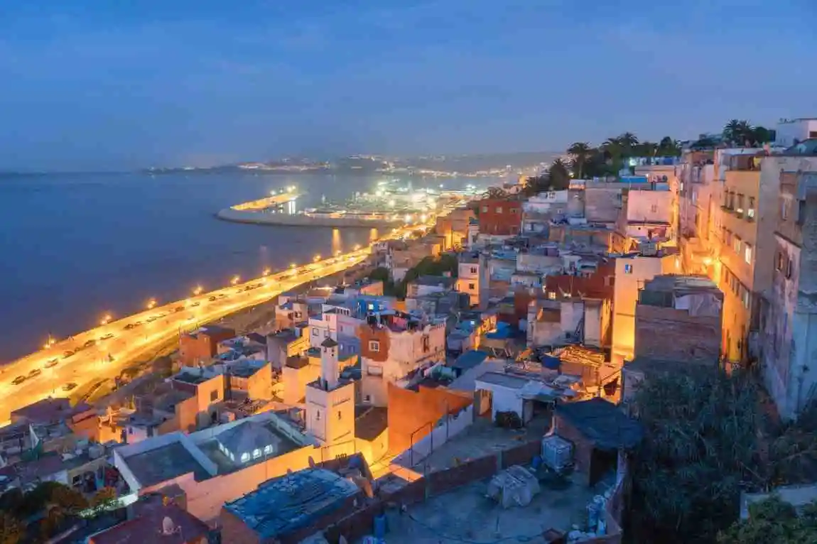 Panoramic night view of Tangier’s coastline and city lights in Morocco.